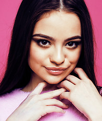 Image showing young pretty teenage woman emotional posing on pink background, fashion lifestyle people concept