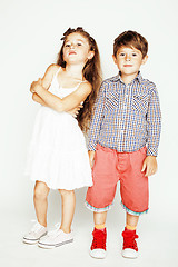 Image showing little cute boy and girl hugging playing on white background, happy smiling family, lifestyle people concept