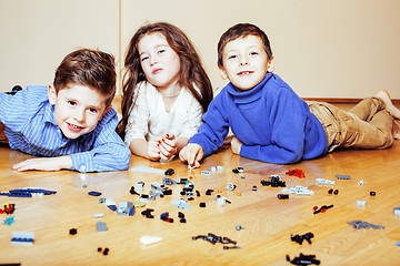 Image showing funny cute children playing lego at home, boys and girl smiling, first education role lifestyle