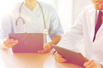 Image showing doctors with tablet pc and clipboard at hospital