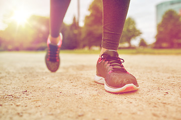 Image showing close up of woman feet running on track from back