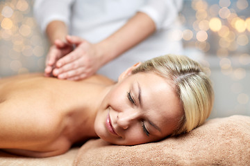 Image showing close up of woman lying and having massage in spa