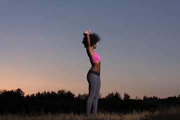 Image showing black woman is doing stretching exercise relaxing and warm up