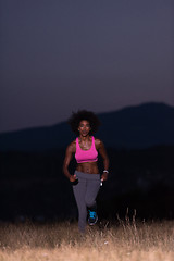 Image showing Young African american woman jogging in nature