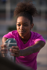 Image showing African American woman doing warming up and stretching