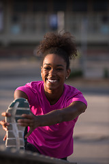 Image showing African American woman doing warming up and stretching