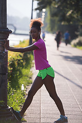 Image showing Black woman doing warming up and stretching