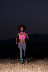 Image showing Young African american woman jogging in nature