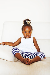 Image showing little pretty african american girl sitting in white chair weari