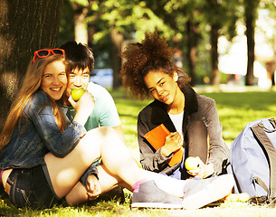 Image showing cute group of teenages at the building of university with books 