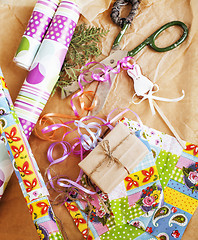 Image showing lot of stuff for handmade gifts, scissors, ribbon, paper with co