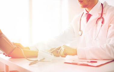 Image showing doctor and patient measuring blood pressure