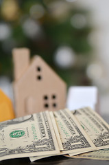 Image showing Miniature paper made house stand on  money