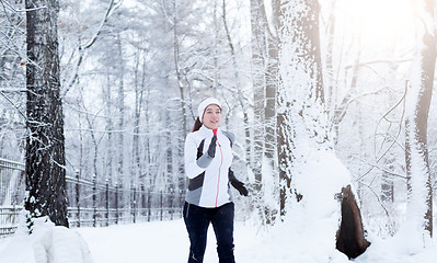 Image showing Girl running in winter park