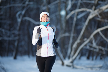 Image showing Girl running in winter park