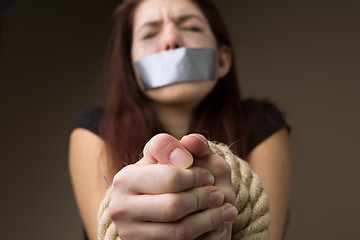 Image showing Brunette gagged and tied hands