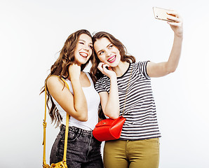 Image showing two best friends teenage girls together having fun, posing emotional on white background, besties happy smiling, making selfie, lifestyle people concept