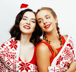 Image showing young pretty happy smiling blond and brunette woman girlfriends on christmas in santas red hat and holiday decorated plaid, lifestyle people concept