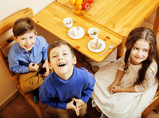 Image showing little cute boys eating dessert on wooden kitchen. home interior. smiling adorable friendship together forever friends, lifestyle people concept