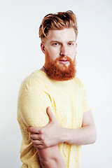 Image showing young handsome hipster ginger bearded guy looking brutal isolated on white background, lifestyle people concept