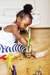 Image showing little cute african american girl playing with animal toys at ho