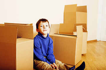 Image showing little cute boy in empty room, remoove to new house. home alone, lifestyle people concept