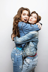 Image showing lifestyle and people concept: Fashion portrait of two stylish sexy girls best friends, over white background. Happy time for fun.