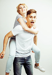 Image showing young pretty teenage couple, hipster guy with his girlfriend happy smiling and hugging isolated on white background, lifestyle people concept