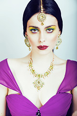 Image showing young pretty caucasian woman like indian in ethnic jewelry close up on white, bridal makeup