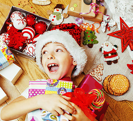 Image showing little cute boy with Christmas gifts at home. close up emotional