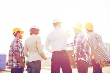 Image showing group of builders and architects at building site