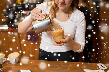 Image showing close up of woman making coffee at shop or cafe