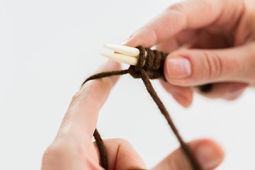 Image showing close up of hands knitting with needles and yarn