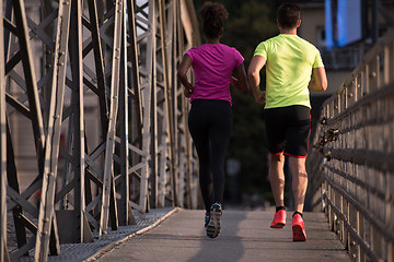 Image showing multiethnic couple jogging in the city