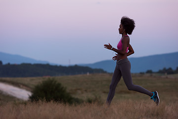 Image showing Young African american woman jogging in nature