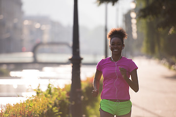 Image showing african american woman jogging in the city