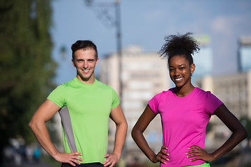 Image showing portrait of young multietnic jogging couple ready to run