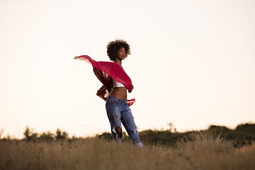 Image showing black girl dances outdoors in a meadow