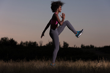 Image showing black woman is doing stretching exercise relaxing and warm up