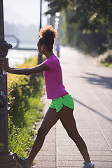 Image showing Black woman doing warming up and stretching