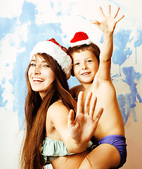 Image showing funny family in red hats celebrating new year, mother with son happy smiling, lifestyle people concept