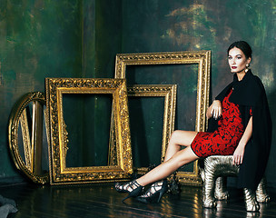Image showing beauty rich brunette woman in luxury interior near empty frames, vintage elegance brunette