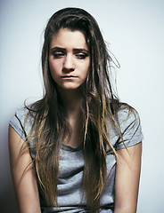 Image showing problem depressioned teenage with messed hair and sad face, real junky bad looking girl close up