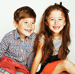 Image showing little cute boy and girl hugging playing on white background, happy family smiling