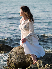 Image showing Lady Sitting on Sea Rock