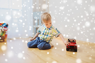 Image showing little baby boy playing with toy car at home