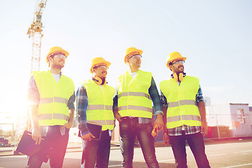 Image showing group of smiling builders with tablet pc outdoors