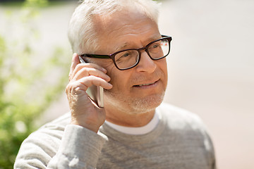 Image showing happy senior man calling on smartphone in city