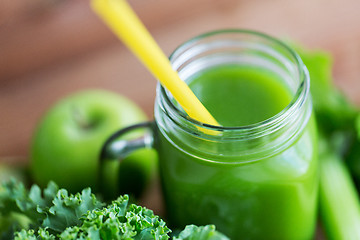 Image showing close up of jug with green juice and vegetables