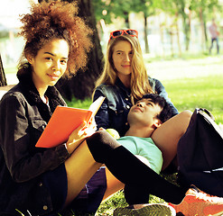 Image showing cute group of teenages at the building of university with books 